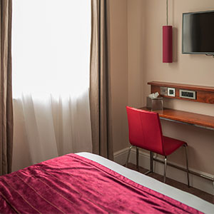 The desk area in the small double room with tea and coffee amenities